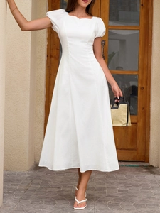 Detail of white A-line dress featuring puff short sleeves and minimalist square neckline