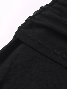 Close-up of black mesh dress showing neat double-needle stitching and fabric texture