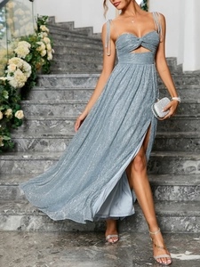 Detail of glittery silver blue strapless dress featuring waist cutout and high leg slit