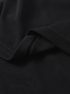 Macro shot of breathable black mesh fabric texture and precise stitching on the long dress
