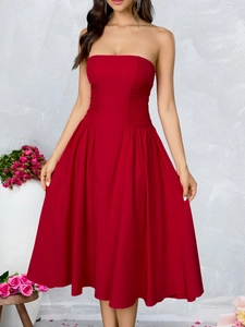 Detailed view of the red strapless midi dress featuring pleated waist and flowy skirt