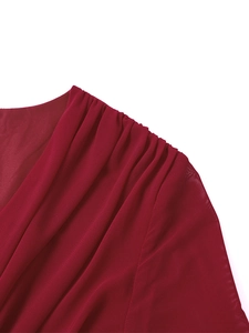 Vue détaillée du tissu en mesh rouge foncé avec épaule plissée et texture légère