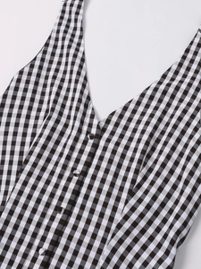 Detail of Gingham summer dress featuring a deep V-neckline and fabric-covered buttons