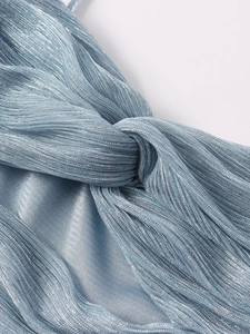 Detailed macro view of light blue pleated fabric with a central knot on a strapless dress