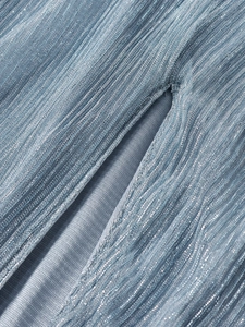Macro detail of light blue metallic pleated fabric with shimmer and slit stitching