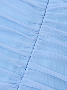 Macro shot of light blue ruched mesh fabric texture with elegant pleated detailing