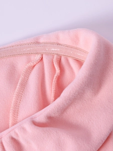 Close-up of pink velvet dress showing internal stitching and hidden elastic waistband