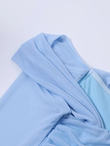 Detailed close-up of light blue sheer mesh fabric with elegant ruched textures and seams