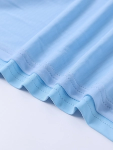 Detail of light blue mesh fabric with breathable holes and neat double-needle stitching