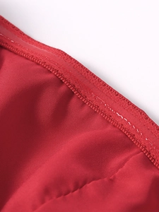Detail view of red dress inner lining featuring transparent silicone non-slip grip strip