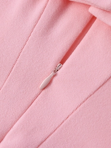 Detail of invisible pink zipper on back of fitted velvet texture party mini dress