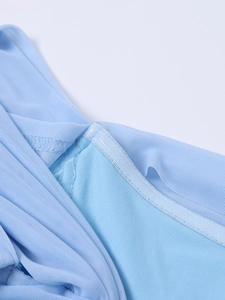 Detailed close-up showing light blue mesh fabric layers and professional stitching on dress