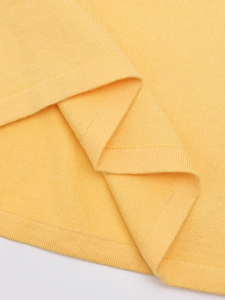 Close-up of bright yellow knit fabric texture showing high-quality stitching detail