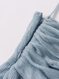 Detail of light blue pleated glitter fabric featuring a color-matched invisible zipper closure