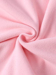 Close-up macro view of soft pink velvet knit fabric texture with fine fuzzy pile finish