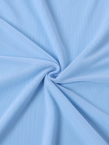 Macro view of light blue mesh fabric showing fine breathable holes and soft texture