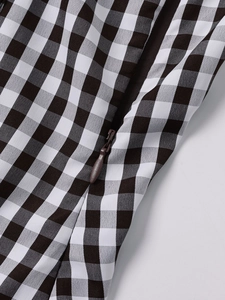 Close-up of the high-quality invisible zipper on the black and white gingham dress fabric