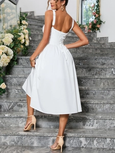 Detailed back view of a white lace-up dress showing elegant cross straps and metal eyelets