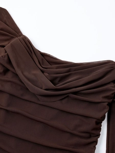 Detail of coffee brown sheer mesh fabric with elegant ruching and layered texture