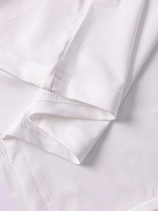 Detailed close-up showing high-quality double-stitch hem on white milk silk fabric
