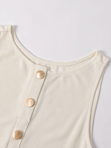 Close-up of beige ribbed knit dress featuring elegant gold buttons and round neckline