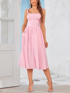 Close-up of pink midi dress featuring lace trim, decorative buttons and pleated skirt detail