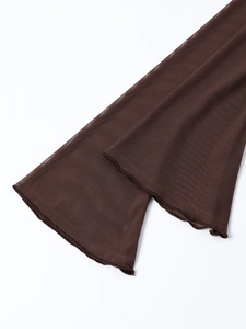 Macro detail of sheer brown mesh fabric with elegant wave-edge lettuce trim on sleeve