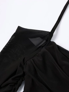 Detail of sheer black mesh fabric with spaghetti straps and ruched pleated stitching