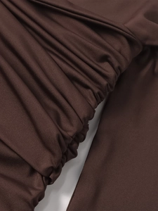 Close-up detail of dark brown milk silk dress featuring elegant ruched texture and elastic fabric
