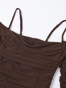 Close-up of ruched texture on dark brown sheer mesh dress with adjustable straps