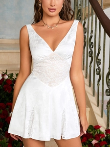 Close-up of white satin A-line dress with rose jacquard and intricate lace details