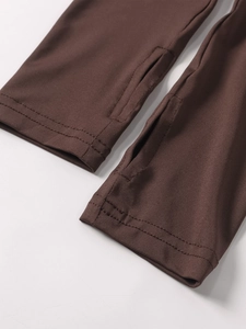 Macro detail of dark brown elastic knit sleeve featuring a functional thumbhole cuff