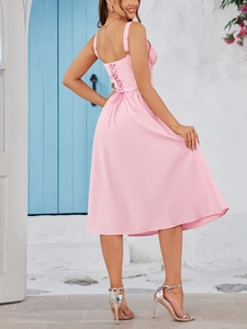 Detailed back view of light pink dress featuring adjustable lace-up drawstring design