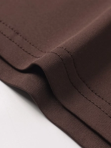 Detail of chocolate brown ribbed fabric with professional double-needle stitching