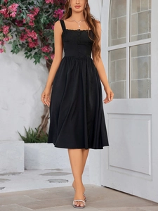 Close-up of elegant lace trim and decorative buttons on the black midi A-line dress