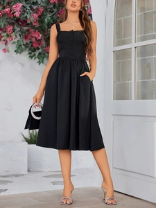 Close-up of black lace-trimmed neckline and button detail on an A-line maxi dress
