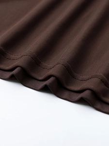 Close-up of brown honeycomb mesh fabric with high-quality double-needle stitching detail