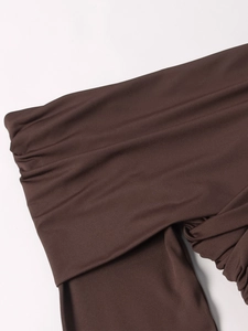 Detailed view of dark brown milk silk dress with elegant draped pleated fabric design