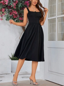 Detail of elegant black lace strap midi dress with button front and pleated A-line hem