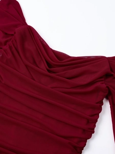 Close-up of ruched wine red mesh fabric showing breathable texture and elegant draped layers