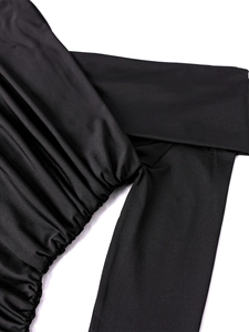 Detailed view of the black milk silk fabric with elegant ruching and fine stitching quality