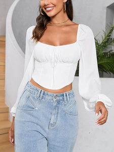 Detail of square neckline with drawstring pleats and lantern sleeves on white crop top