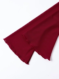 Close-up of burgundy mesh fabric detail with delicate ruffle edge craftsmanship
