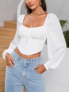 Detail of white square neck crop top with ruched bust and elegant long sleeves