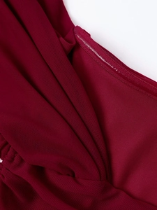 Close-up of wine red mesh dress fabric featuring pleated texture and anti-slip silicone strip