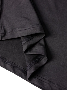 Close-up of the double-needle stitching and fine knit texture on the black dress fabric
