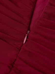 Close-up of invisible zipper and gathered mesh fabric on burgundy bodycon dress