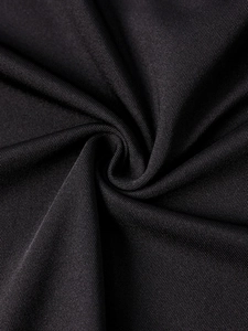 Macro detail of soft black milk silk fabric with a subtle satin sheen and elastic texture