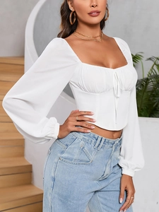 Detail of square neck crop top with drawstring tie and elegant puff sleeves