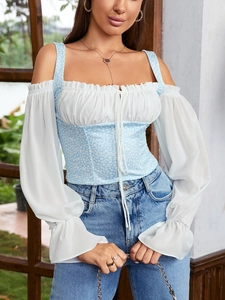 Close-up of floral print waist detail and ruffled sleeves on a sexy chiffon top